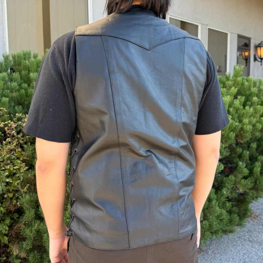 A man wearing a black leather vest