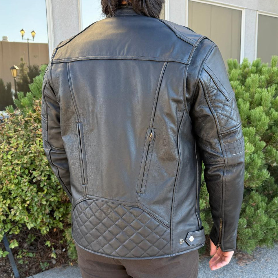 A man wearing a black leather motorcycle jacket