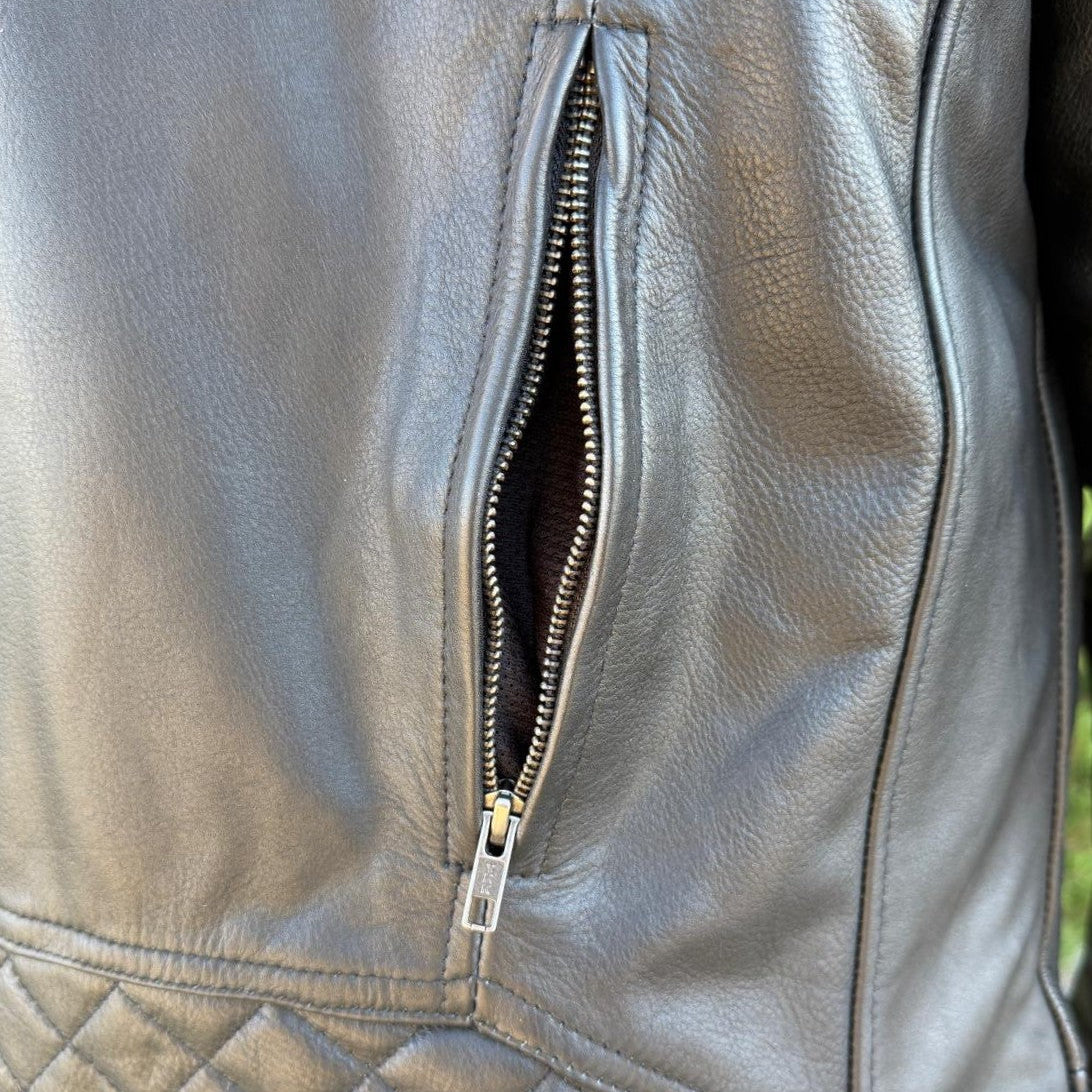 A man wearing a black leather motorcycle jacket