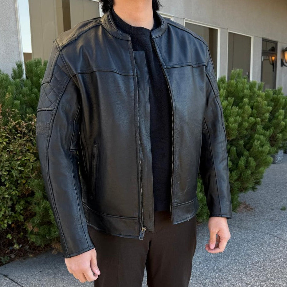 A man wearing a black leather motorcycle jacket