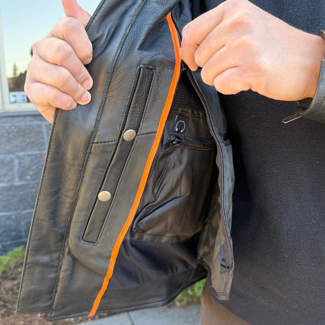 A man wearing a black leather motorcycle jacket