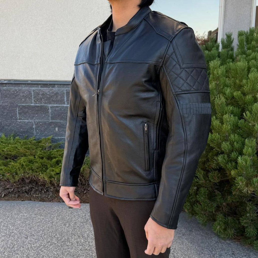 A man wearing a black leather motorcycle jacket