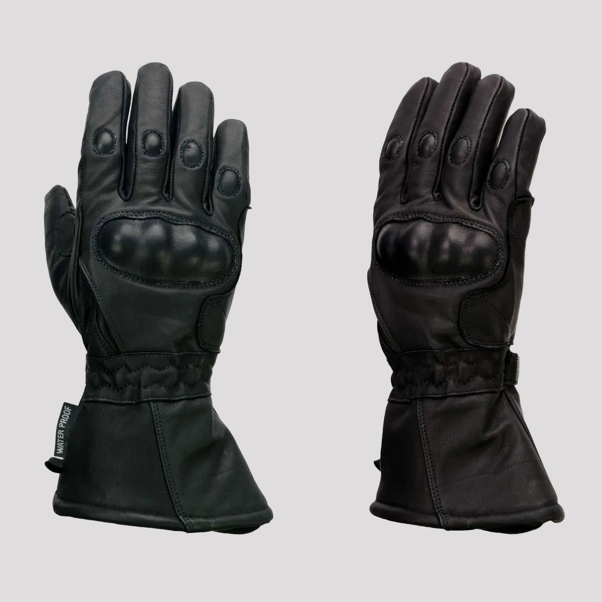 Pair of black gloves with waterproof and knuckle protection features on a beige background.