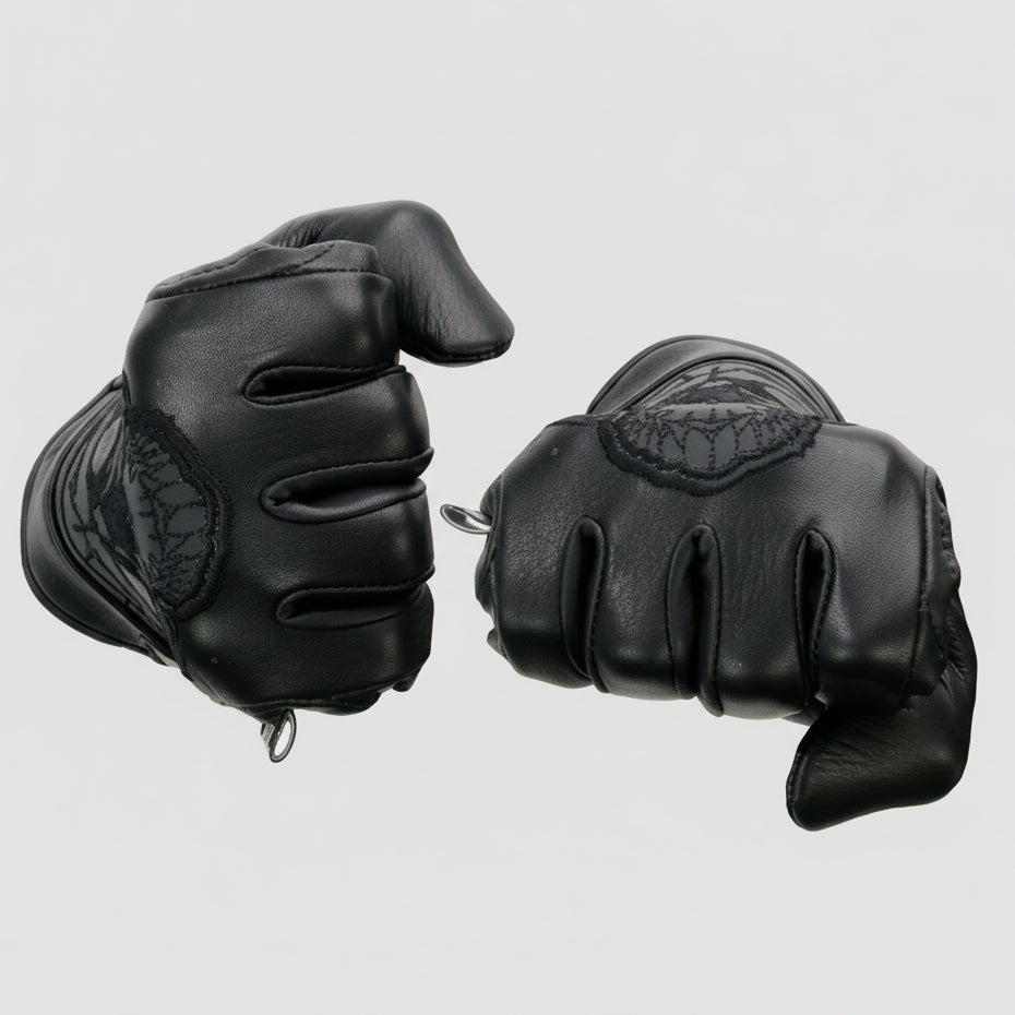 Black gloves with gel palm and reflective material on a beige background