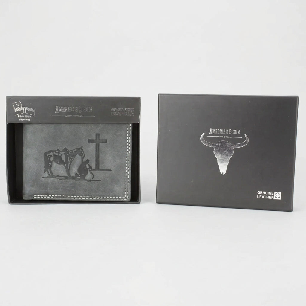 A black leather bi-fold wallet with a western-themed embossed design of a cowboy, horse, and cross, shown next to its black presentation box on a white background.