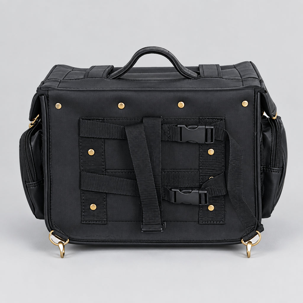Black leather motorcycle luggage bag with multiple front utility straps, buckle closures, and brass grommets