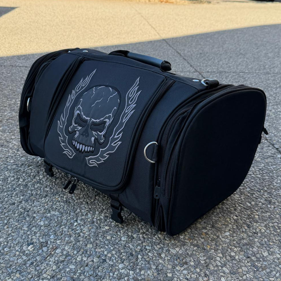 Black duffel bag with a large white skull and laurel design on the front.