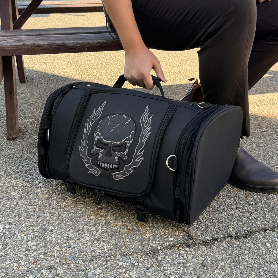 Black duffel bag with a large white skull and laurel design on the front.