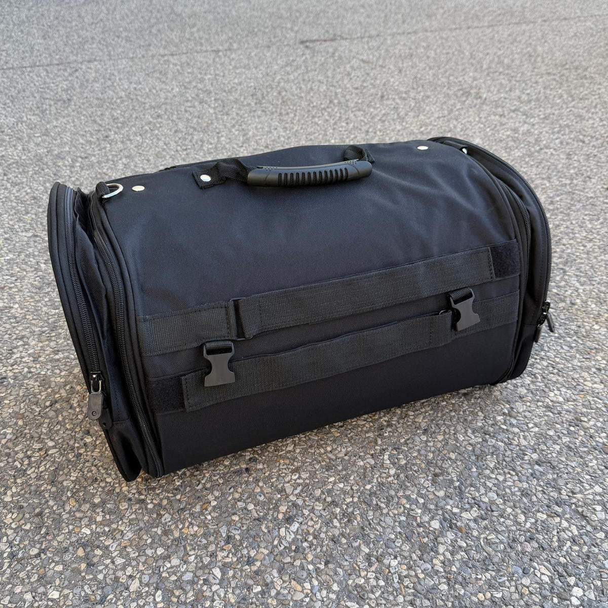 Black duffel bag with a large white skull and laurel design on the front.