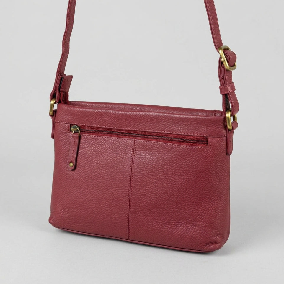 A burgundy pebbled leather crossbody bag with gold-tone hardware