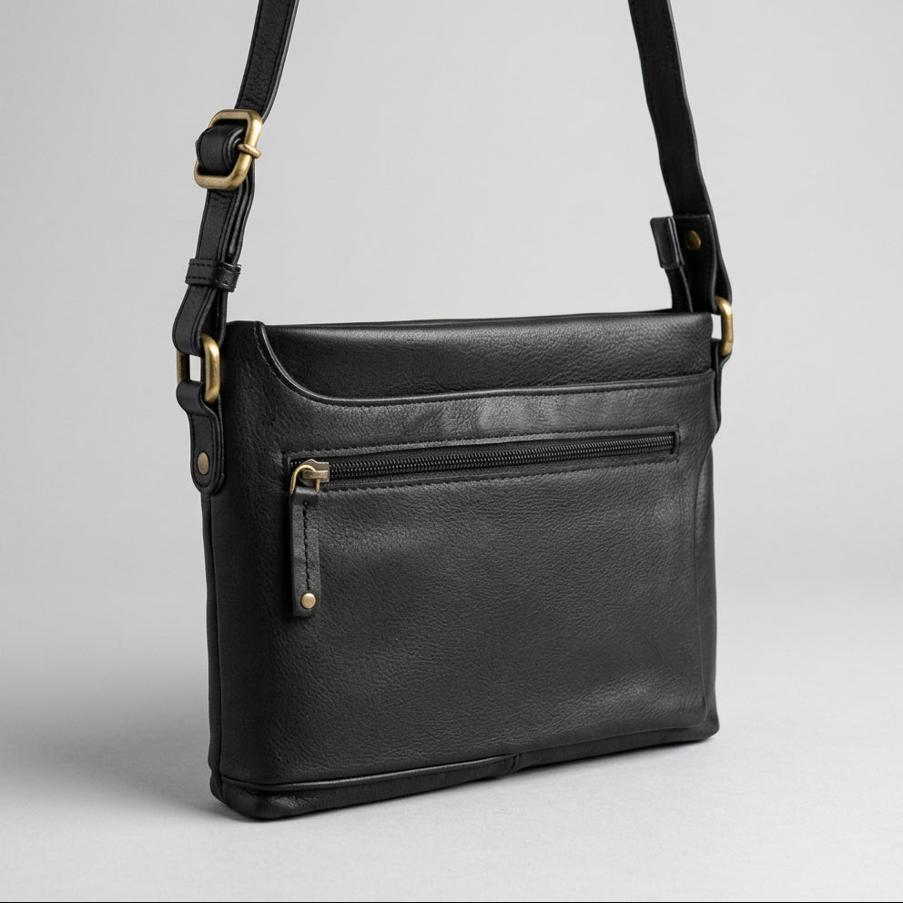Black leather crossbody bag with a front zippered pocket and gold-tone hardware