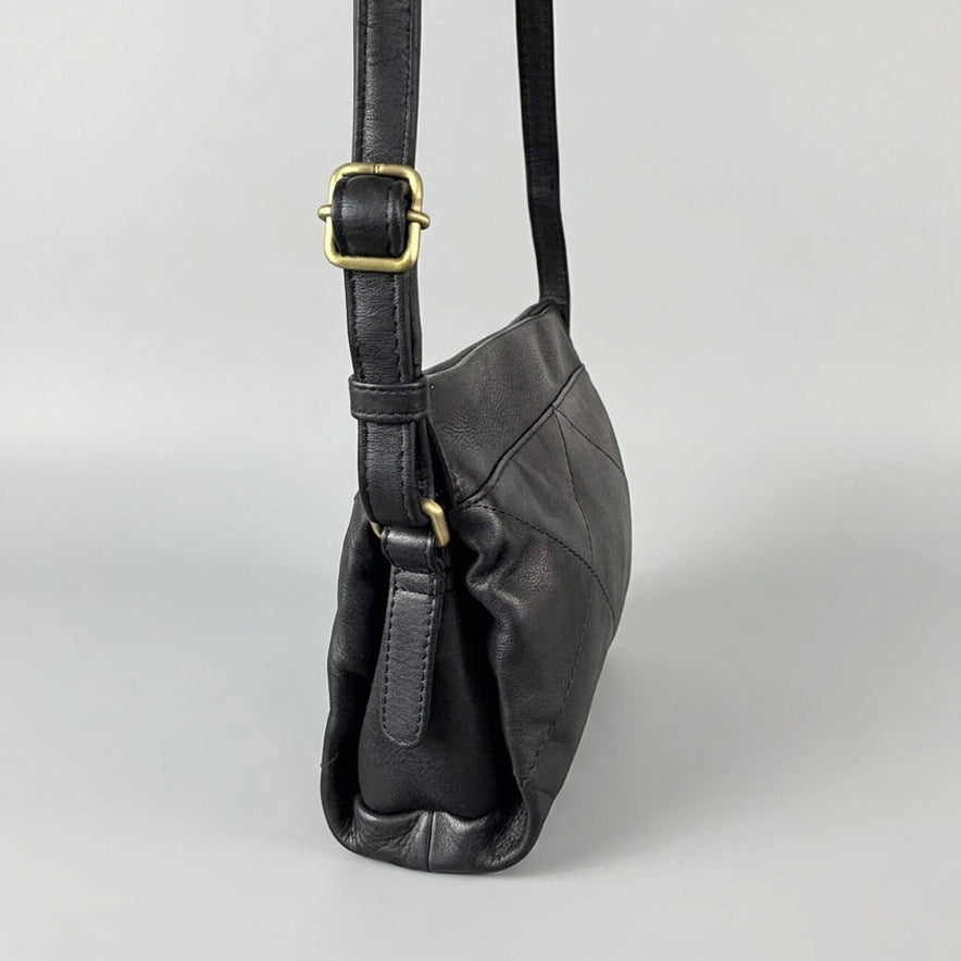 A black leather shoulder bag with a gold buckle