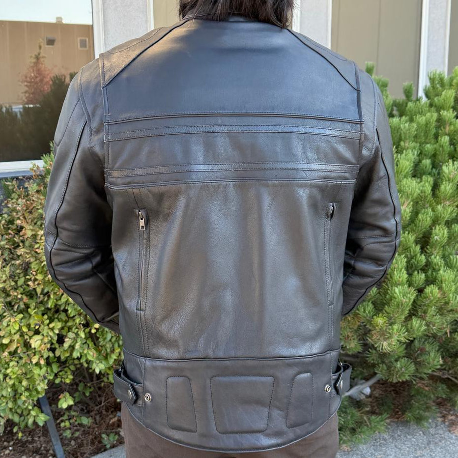 A man wearing a black leather motorcycle jacket
