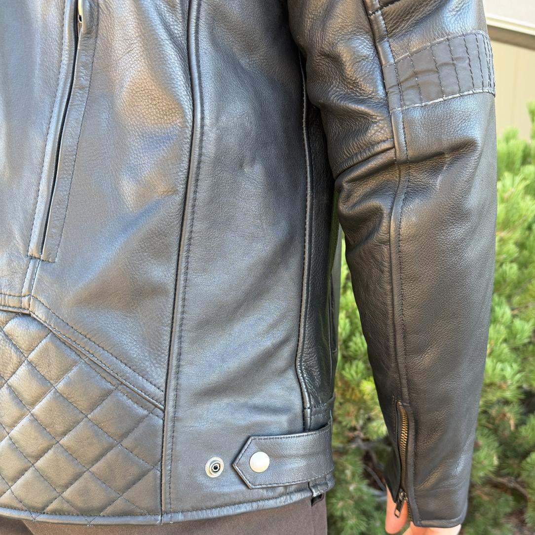 A man wearing a black leather motorcycle jacket