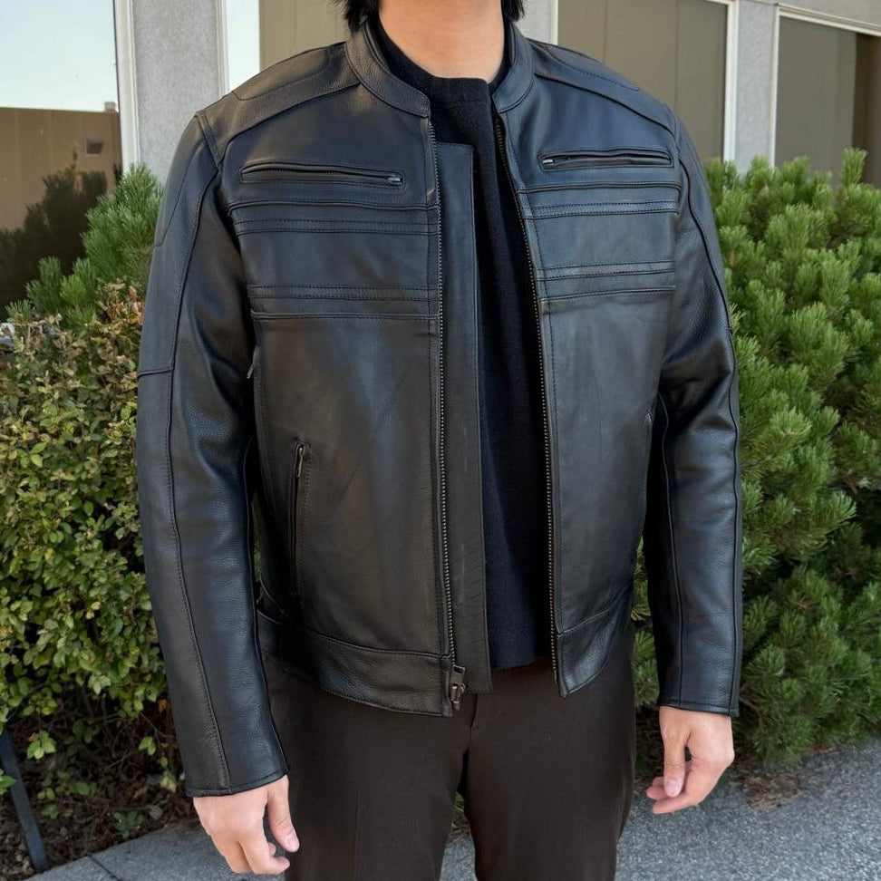 A man wearing a black leather motorcycle jacket