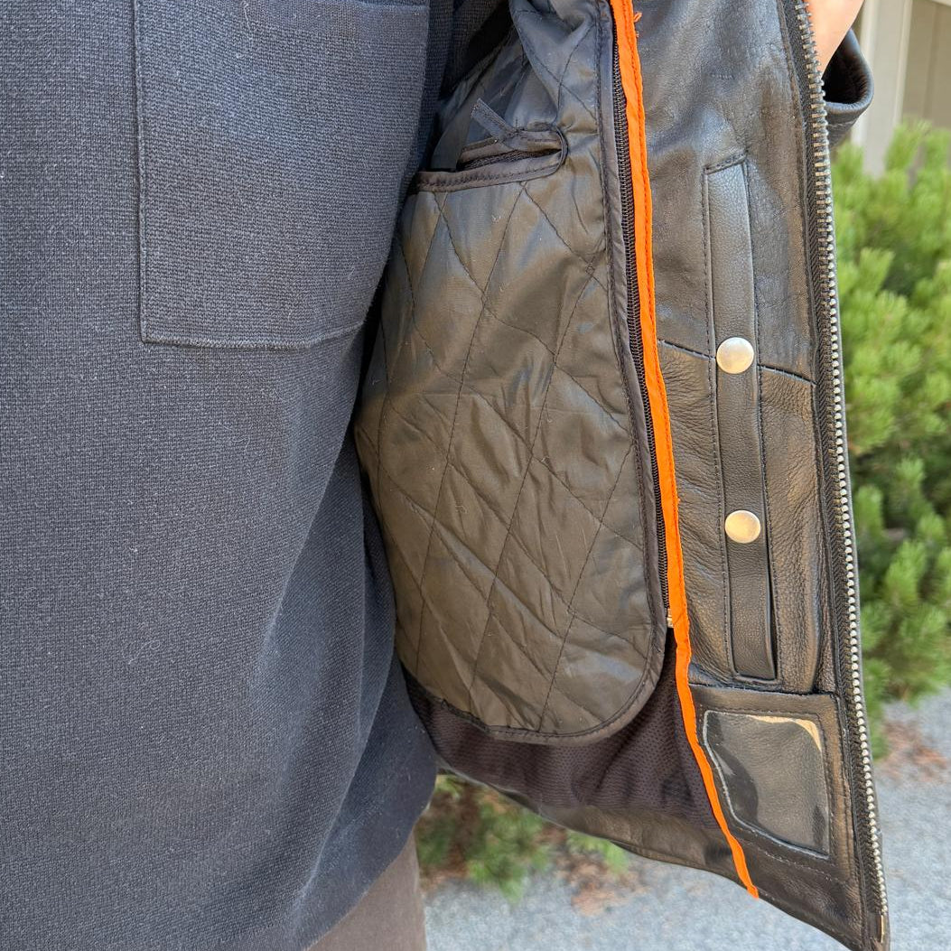 A man wearing a black leather motorcycle jacket