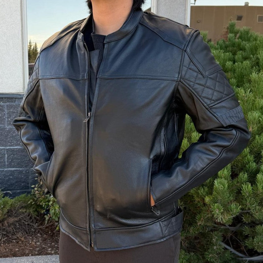 A man wearing a black leather motorcycle jacket