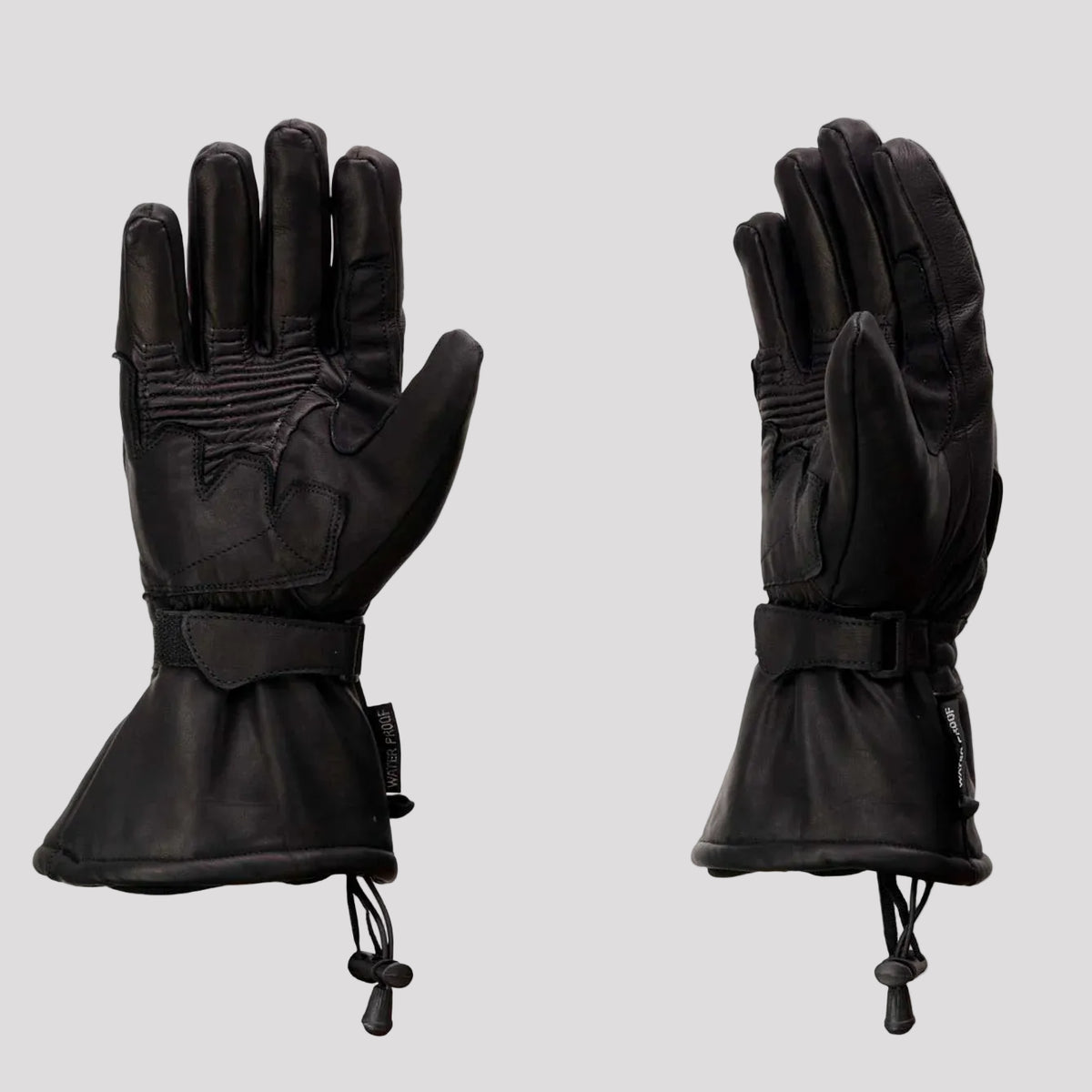 Pair of black gloves with waterproof and knuckle protection labels on a beige background