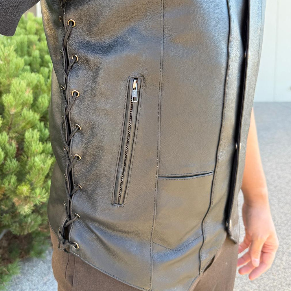 A man wearing a black leather vest
