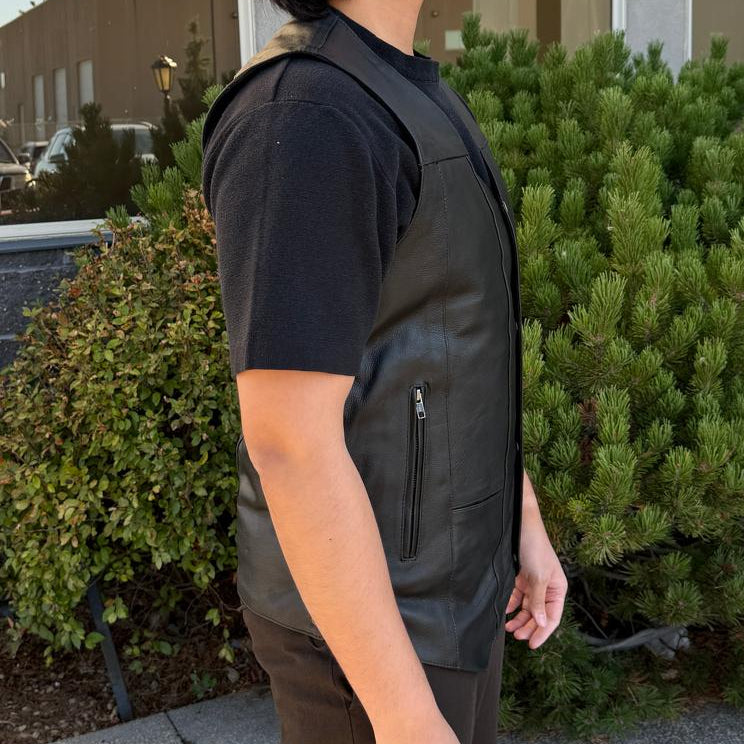 A man wearing a black leather vest