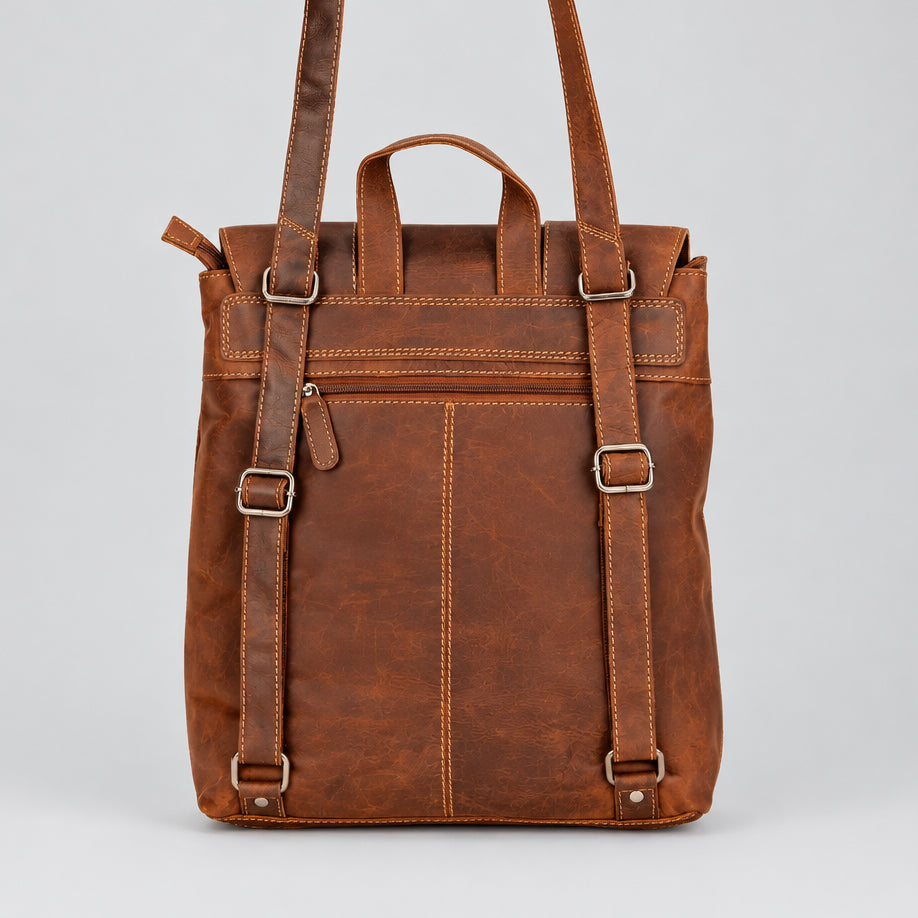 A brown distressed leather backpack with top handles, buckle straps, and a back zippered pocket