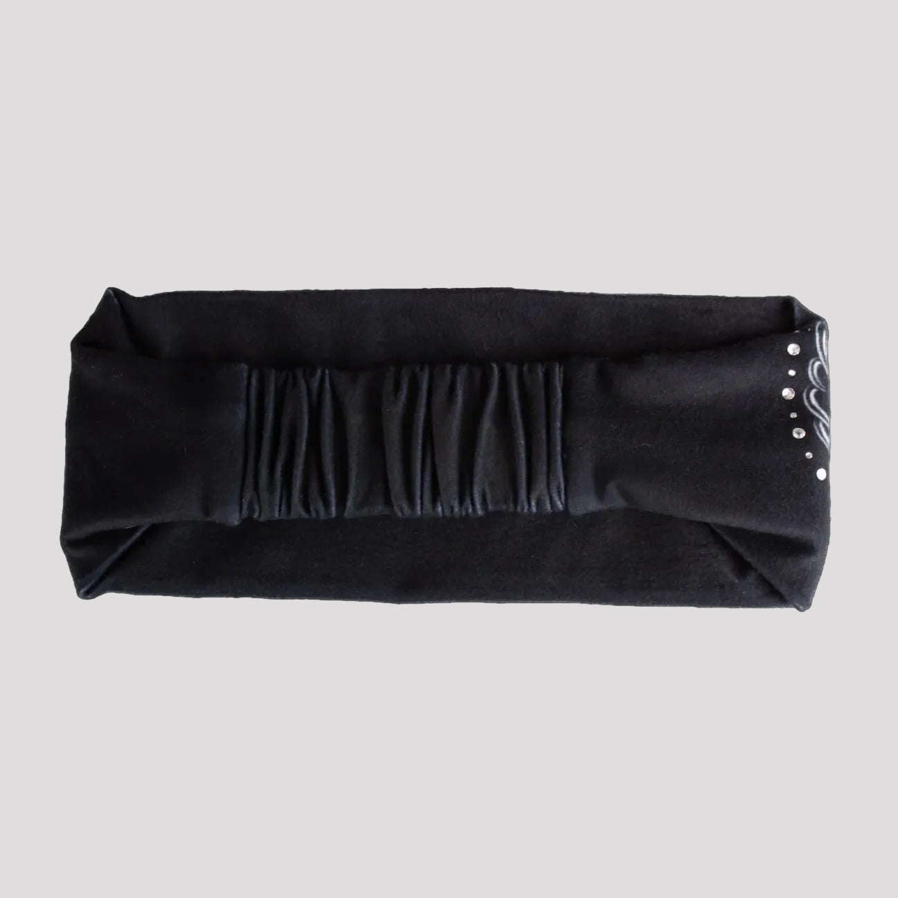 Black headband with decorative elements on a white background