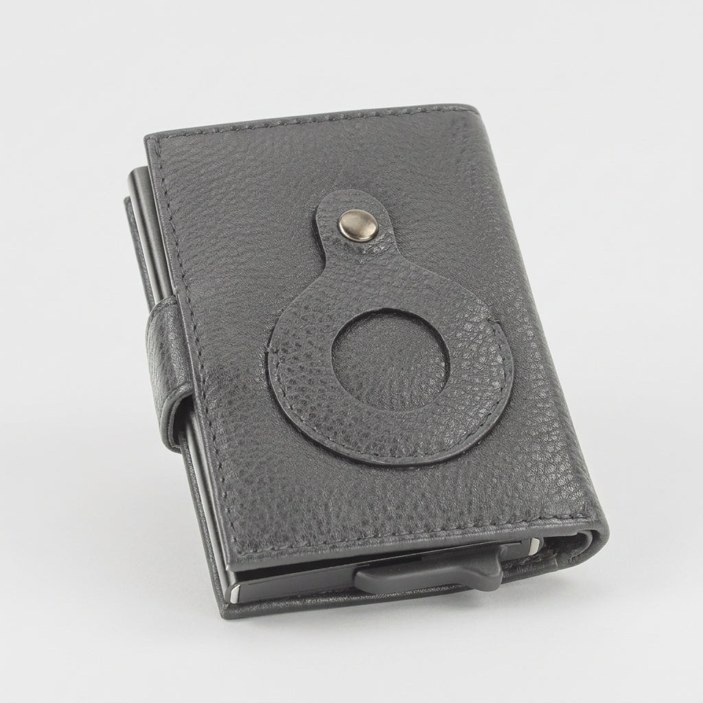 A black textured leather wallet with a circular ring holder and a small gold-tone snap button