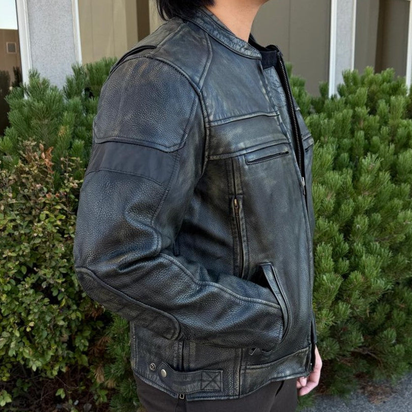 A man wearing a distressed brown leather motorcycle jacket