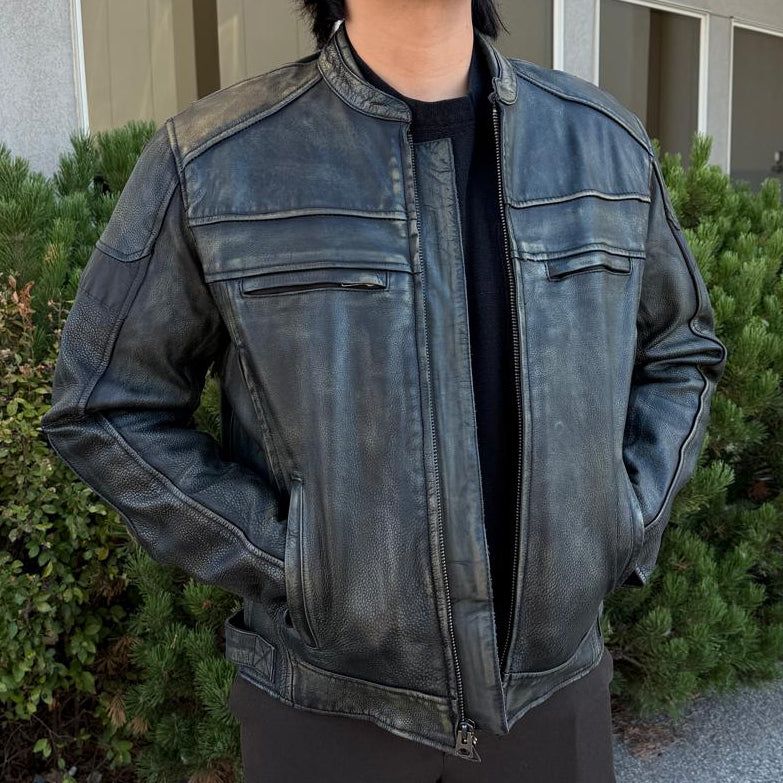A man wearing a distressed brown leather motorcycle jacket