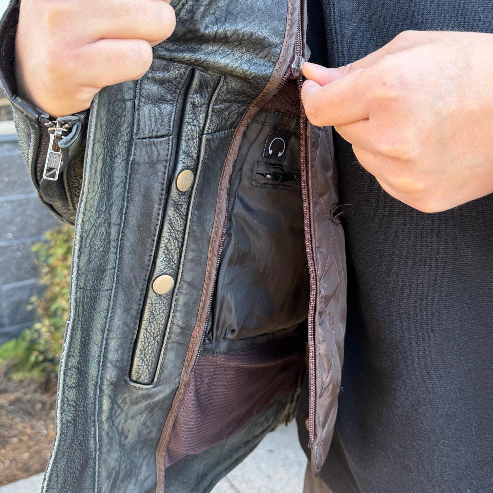 A man wearing a distressed brown leather motorcycle jacket