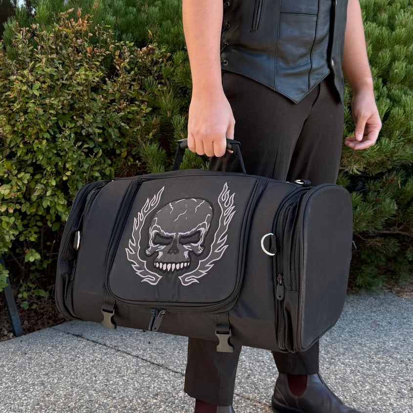 Black duffel bag with a large white skull and laurel design on the front.