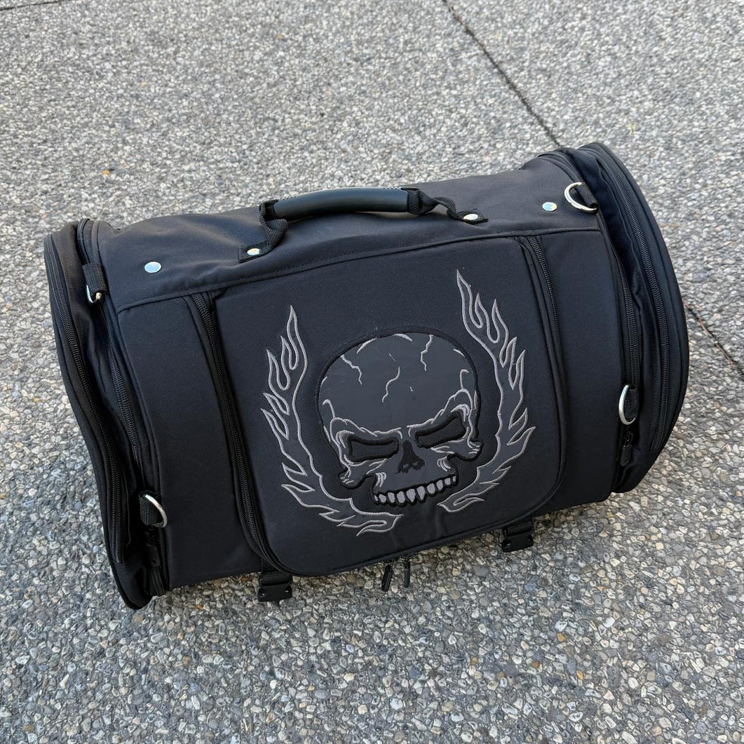 Black duffel bag with a large white skull and laurel design on the front.