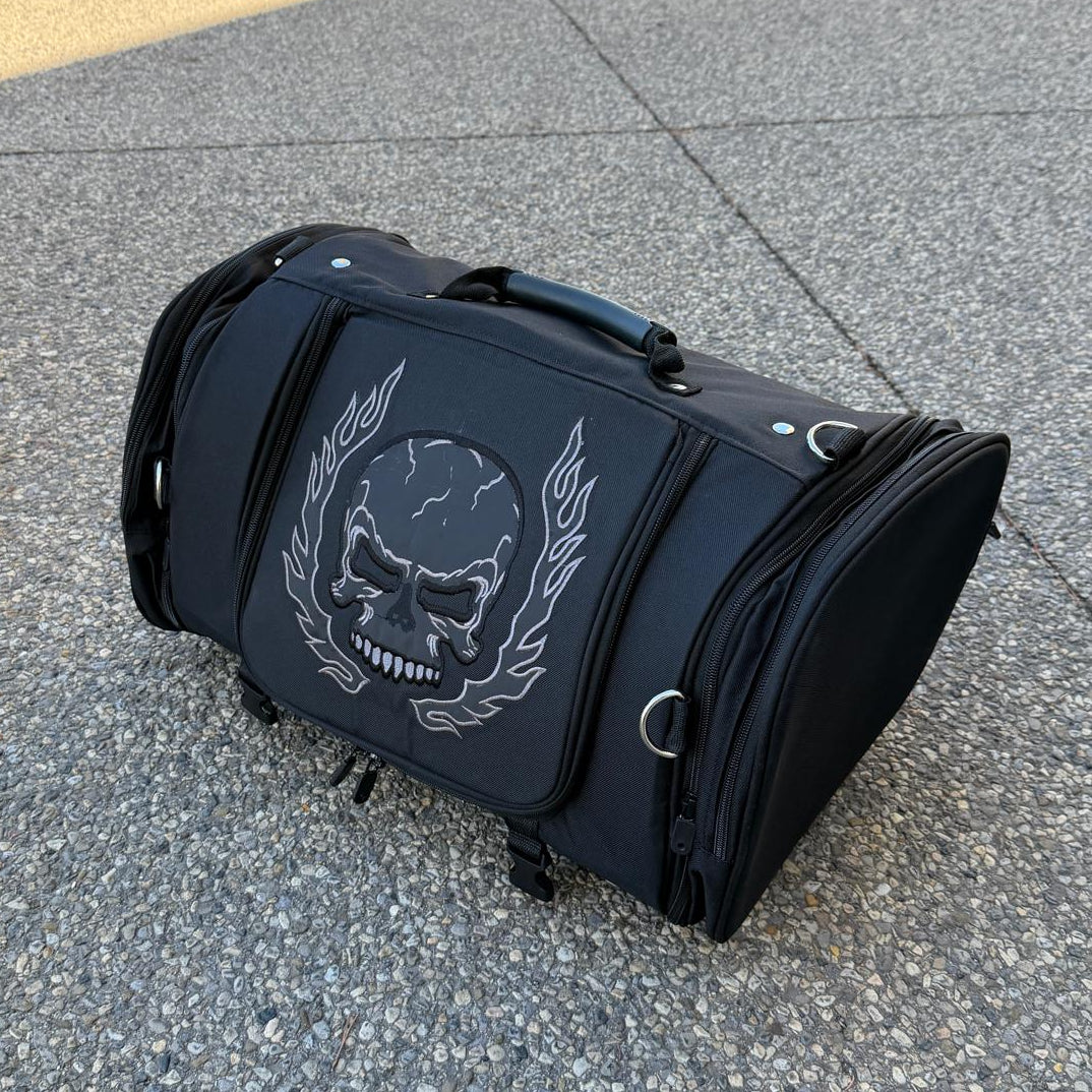 Black duffel bag with a large white skull and laurel design on the front.