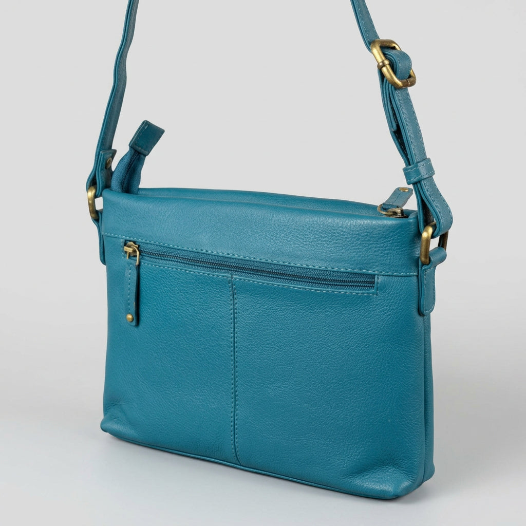 A teal blue pebbled leather crossbody bag with gold-tone hardware