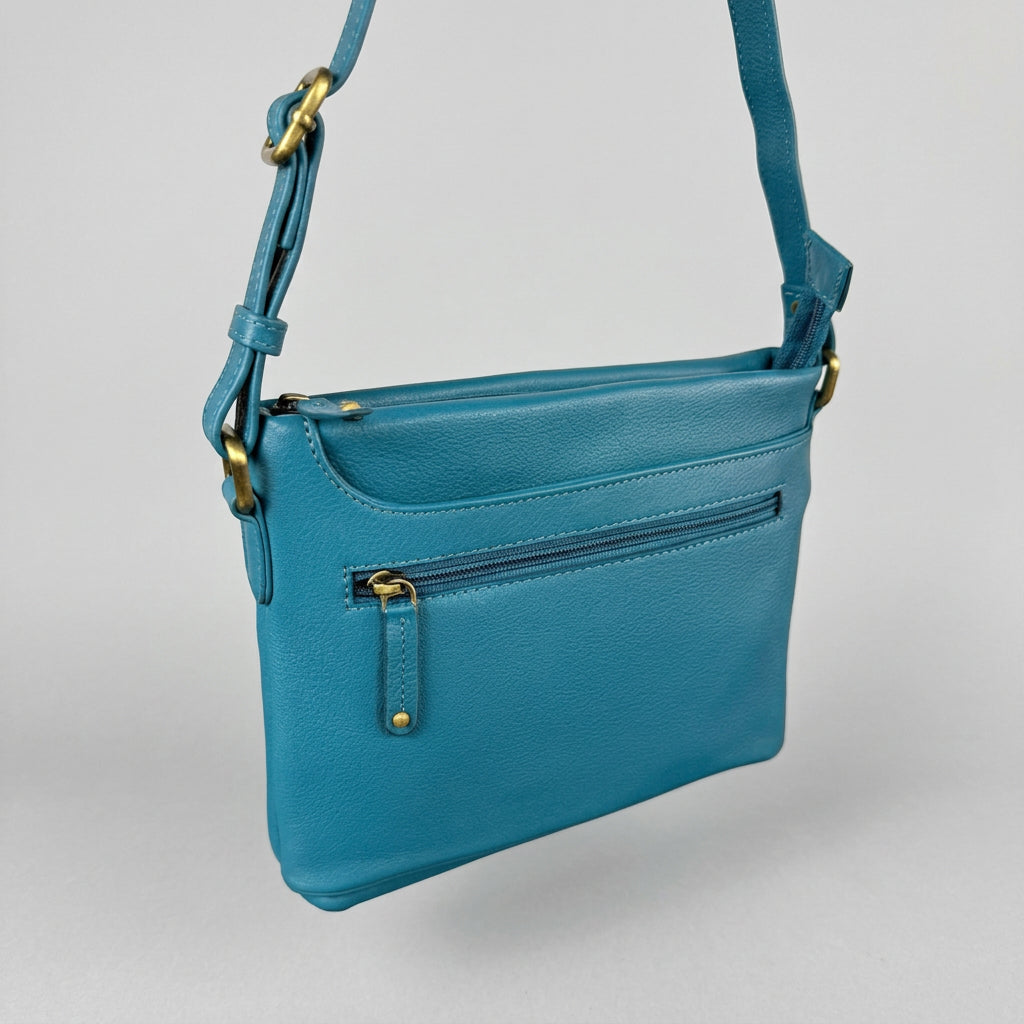 A teal blue leather crossbody handbag with gold-tone hardware