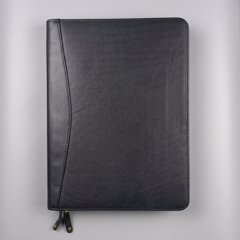 A black leather zippered notebook cover with a curved spine detail