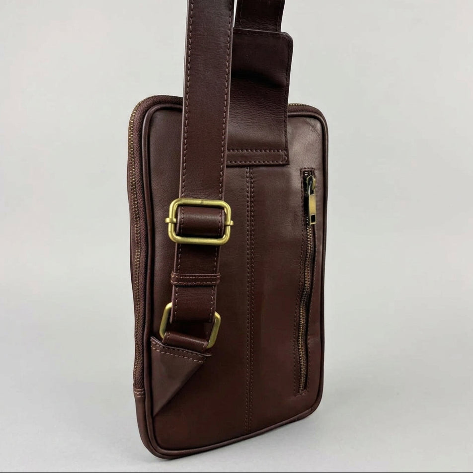 A dark brown leather crossbody phone bag with gold-tone hardware