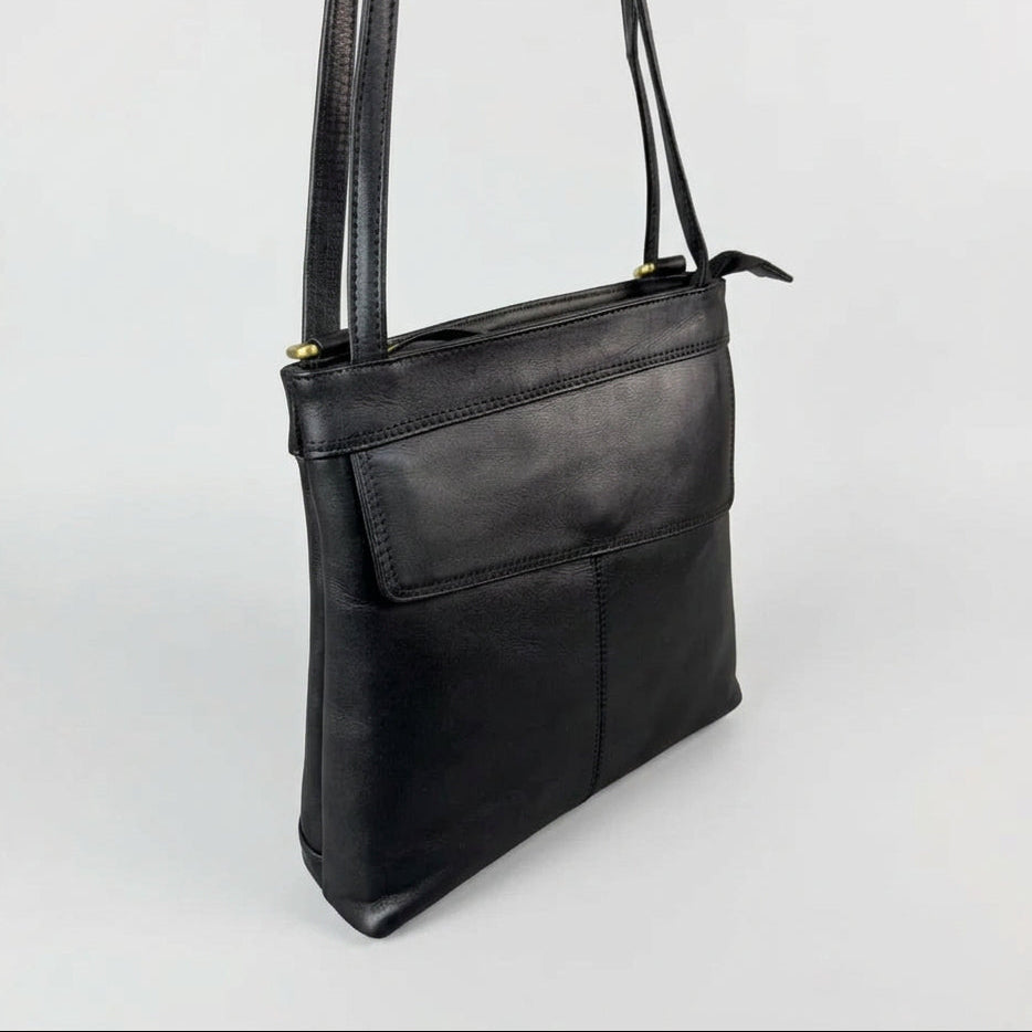 A black leather shoulder bag with a front pocket and gold-tone hardware