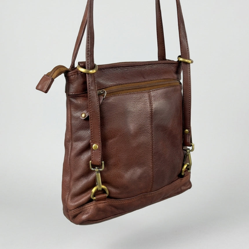 A brown leather crossbody bag with brass hardware